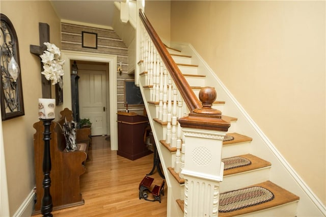 stairs featuring wood finished floors