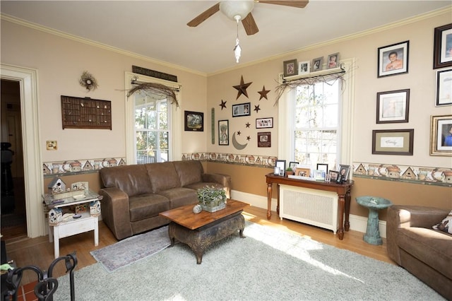 living room featuring ceiling fan, wood finished floors, radiator heating unit, and ornamental molding