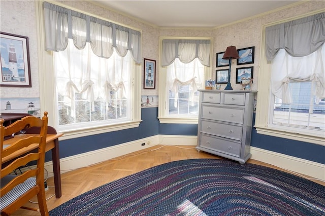 interior space with wallpapered walls, crown molding, and baseboards