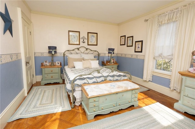 bedroom featuring crown molding, baseboards, and wood finished floors