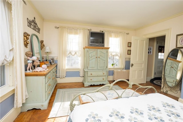 bedroom featuring radiator heating unit, baseboards, and ornamental molding