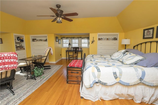 bedroom with lofted ceiling and wood finished floors