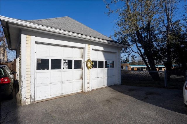 detached garage featuring fence