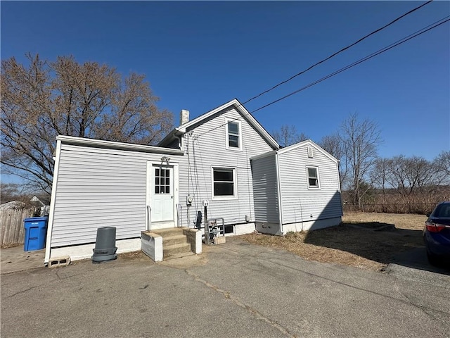 25 N Union St, Lincoln, RI 02865 - rear view of house featuring a chimney