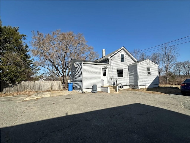 25 N Union St, Lincoln, RI 02865 - rear view of property with fence and a chimney