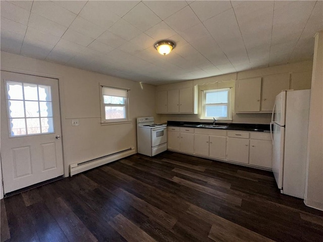 25 N Union St, Lincoln, RI 02865 - kitchen with white appliances, a baseboard heating unit, dark countertops, dark wood-type flooring, and plenty of natural light