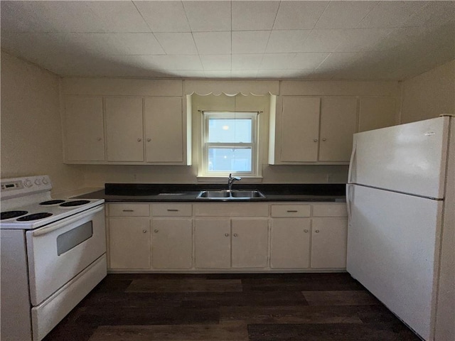 25 N Union St, Lincoln, RI 02865 - kitchen with white appliances, a sink, dark wood-style floors, white cabinetry, and dark countertops