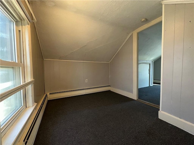 25 N Union St, Lincoln, RI 02865 - additional living space with dark colored carpet, a baseboard heating unit, lofted ceiling, and a textured ceiling