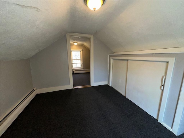 25 N Union St, Lincoln, RI 02865 - bonus room featuring baseboard heating, baseboards, vaulted ceiling, a textured ceiling, and dark colored carpet