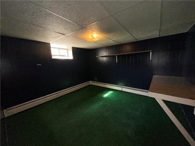 25 N Union St, Lincoln, RI 02865 - below grade area featuring a baseboard heating unit, wood walls, a paneled ceiling, and baseboards