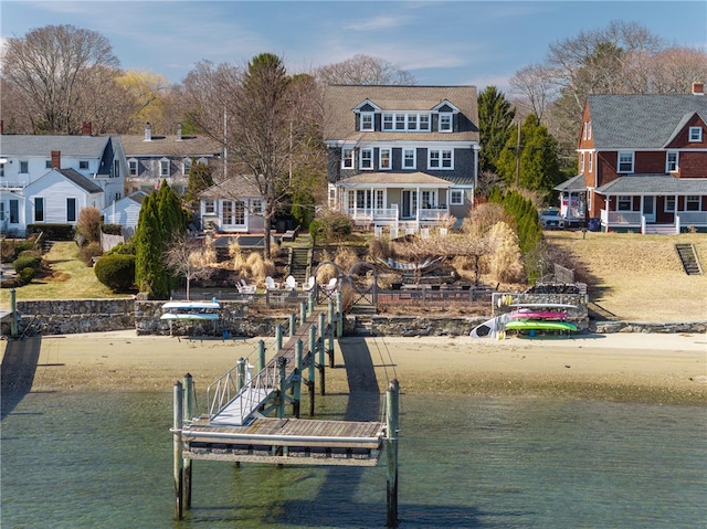 view of dock with a water view and a residential view
