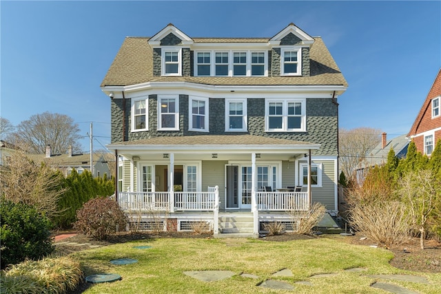 view of front facade featuring a porch, a front lawn, and a shingled roof