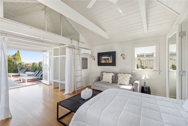 bedroom with wood finished floors, access to exterior, vaulted ceiling with beams, baseboards, and a wall mounted AC