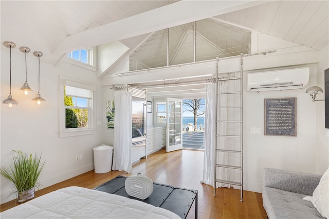 bedroom featuring access to exterior, baseboards, high vaulted ceiling, wood finished floors, and a wall mounted AC