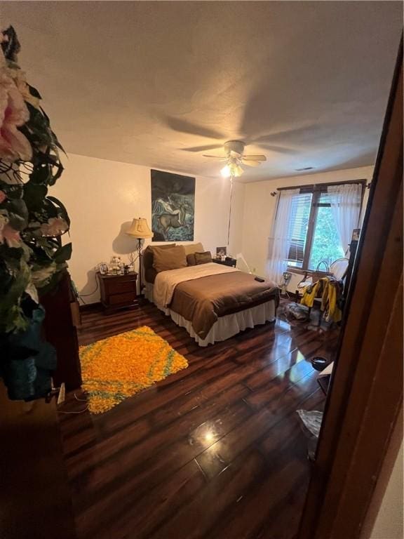 bedroom with a ceiling fan and wood finished floors