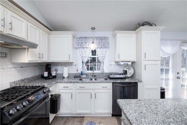 kitchen featuring black range with gas cooktop, backsplash, a sink, dishwasher, and white cabinets
