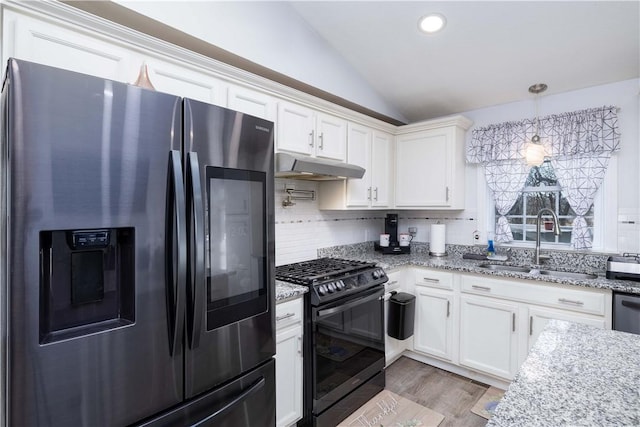 kitchen with under cabinet range hood, lofted ceiling, a sink, black range with gas cooktop, and stainless steel fridge with ice dispenser