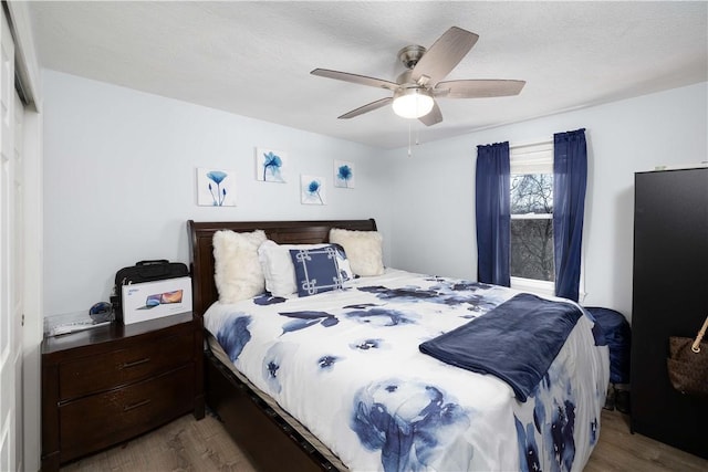 bedroom featuring wood finished floors and a ceiling fan
