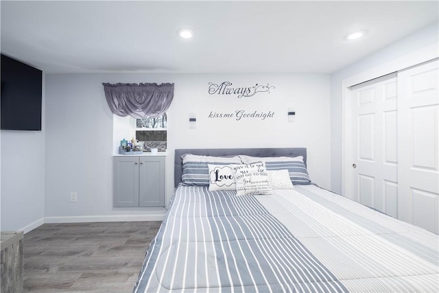 bedroom featuring recessed lighting, baseboards, a closet, and wood finished floors