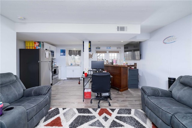 office with visible vents and light wood-style flooring