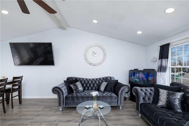 living area with recessed lighting, lofted ceiling with beams, baseboards, ceiling fan, and wood finished floors