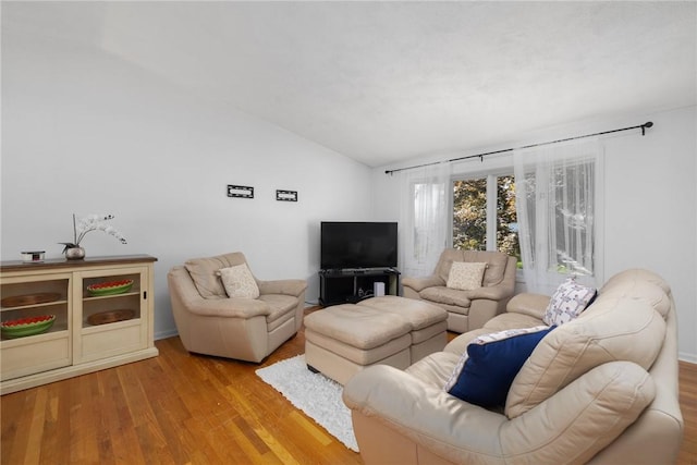 living room with vaulted ceiling and wood finished floors