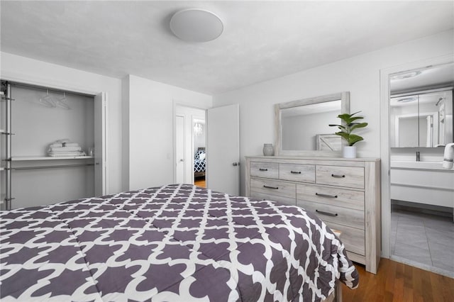 bedroom with a closet and wood finished floors