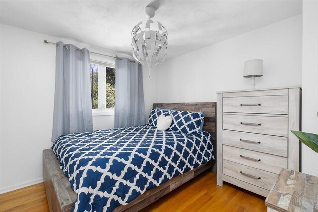 bedroom featuring baseboards and wood finished floors