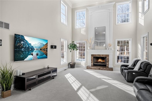 30 Lenihan Ln, East Greenwich, RI 02818 - living room with a towering ceiling, carpet, a fireplace, plenty of natural light, and crown molding