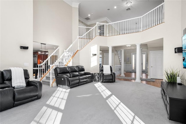 30 Lenihan Ln, East Greenwich, RI 02818 - carpeted living area with decorative columns, a towering ceiling, stairs, crown molding, and recessed lighting