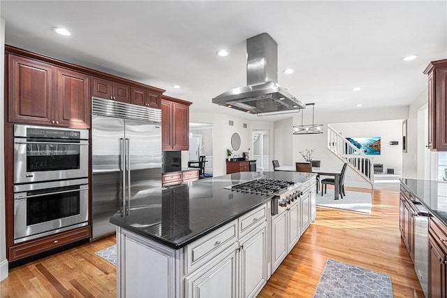 30 Lenihan Ln, East Greenwich, RI 02818 - kitchen featuring appliances with stainless steel finishes, island range hood, a center island, light wood finished floors, and recessed lighting