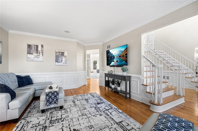 30 Lenihan Ln, East Greenwich, RI 02818 - living room with stairway, crown molding, wood finished floors, a wainscoted wall, and a decorative wall