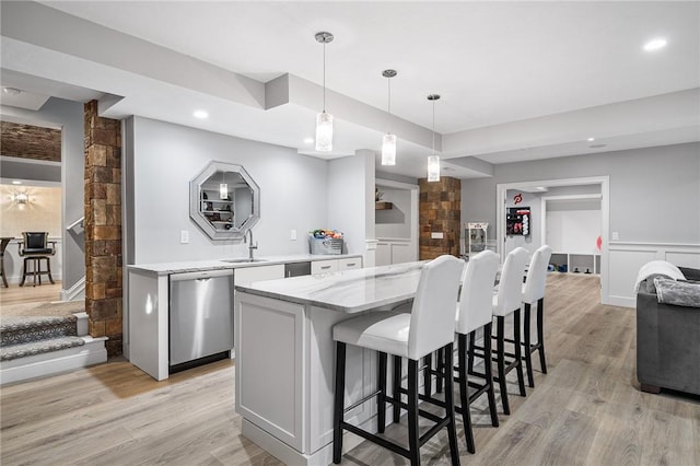 30 Lenihan Ln, East Greenwich, RI 02818 - kitchen with dishwasher, light wood finished floors, hanging light fixtures, a breakfast bar area, and recessed lighting