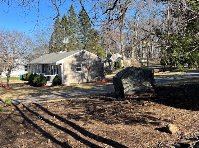 view of side of home with a porch