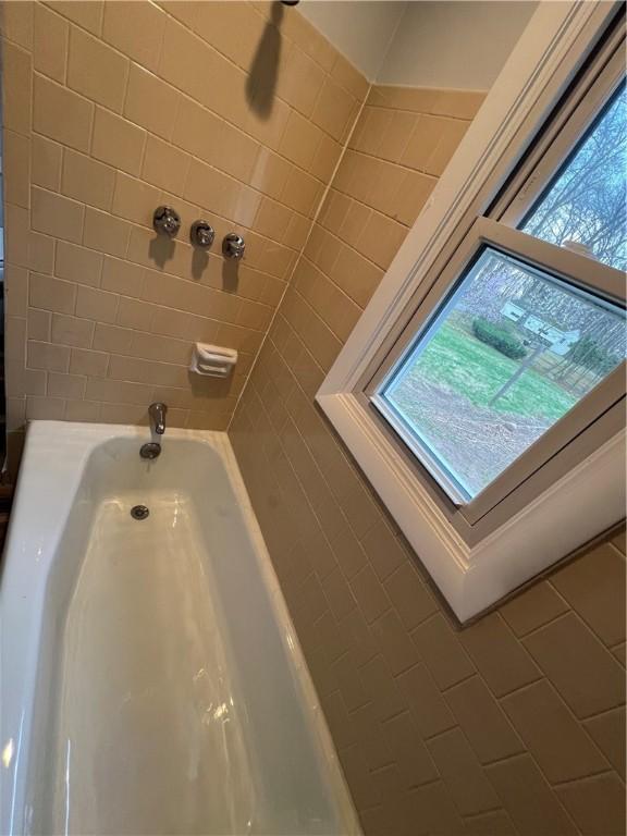 full bath featuring a healthy amount of sunlight