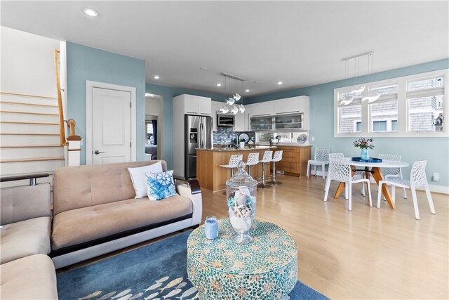 399 Atlantic Ave, Westerly, RI 02891 - living room with light wood finished floors, stairway, recessed lighting, and a chandelier