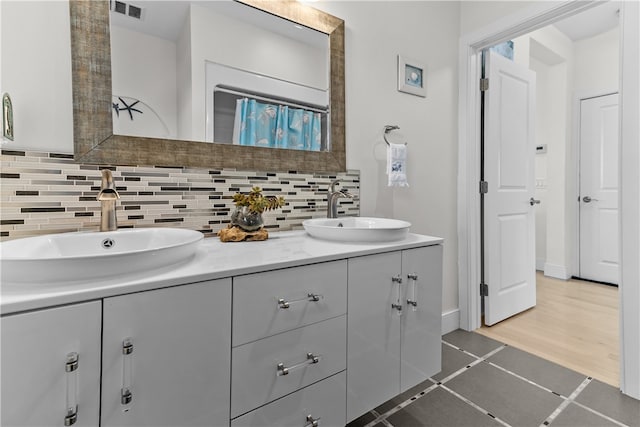 399 Atlantic Ave, Westerly, RI 02891 - bathroom featuring double vanity, tasteful backsplash, and tile patterned floors