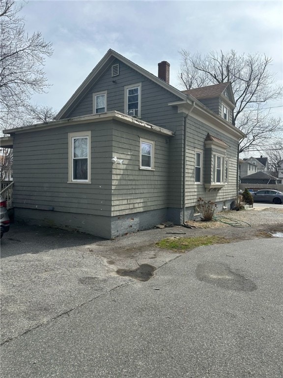 view of property exterior with a chimney