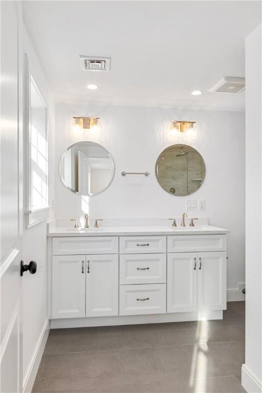full bathroom featuring a sink, visible vents, and double vanity