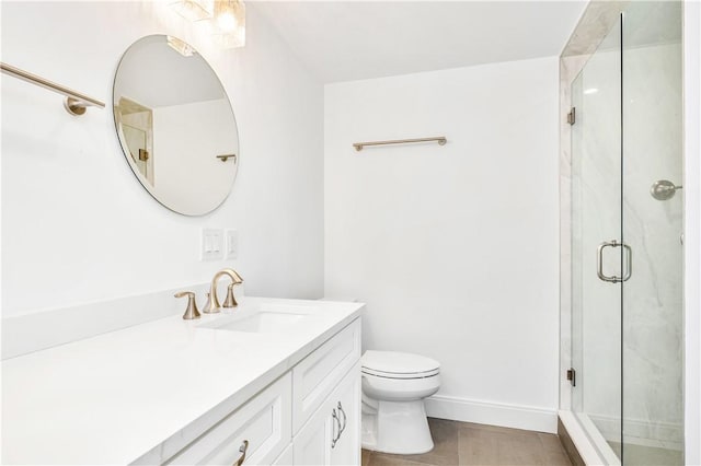 full bathroom featuring tile patterned flooring, a shower stall, baseboards, toilet, and vanity