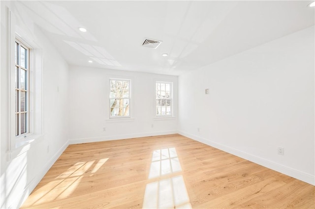 spare room with recessed lighting, light wood-style floors, visible vents, and baseboards