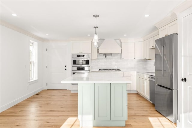 kitchen with stainless steel appliances, tasteful backsplash, custom exhaust hood, and light wood finished floors