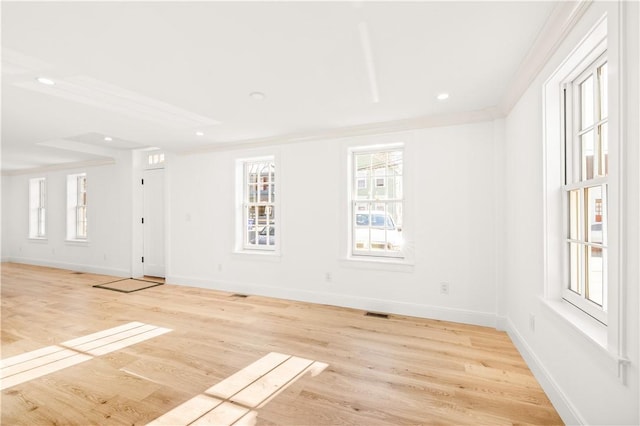 unfurnished room with recessed lighting, light wood-type flooring, baseboards, and ornamental molding