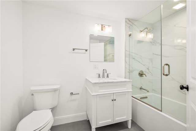 bathroom featuring baseboards, toilet, vanity, and bath / shower combo with glass door