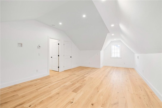 bonus room featuring light wood finished floors, recessed lighting, baseboards, and lofted ceiling