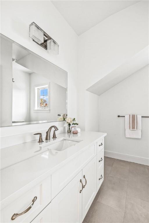 bathroom featuring tile patterned floors, baseboards, and vanity