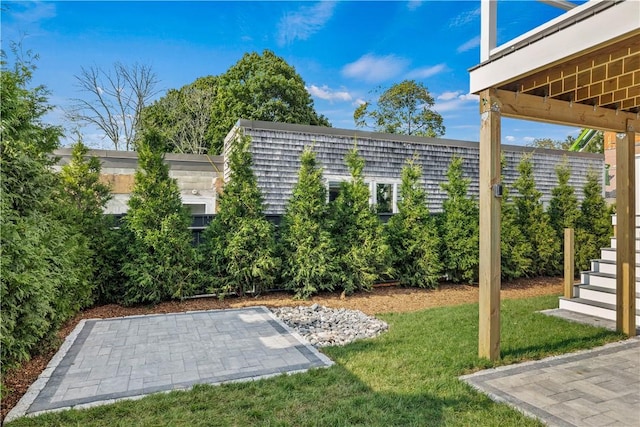 view of yard with stairway, a patio area, and fence