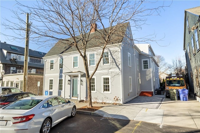view of front of property with a residential view and a chimney
