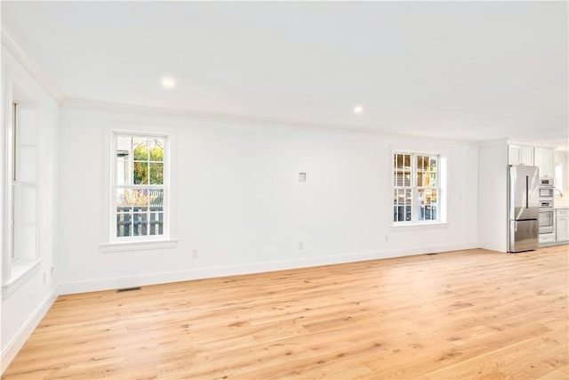 spare room with visible vents, crown molding, baseboards, recessed lighting, and light wood-style flooring