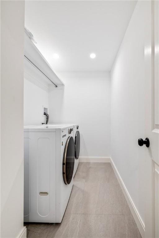 clothes washing area featuring washer and dryer, laundry area, recessed lighting, and baseboards